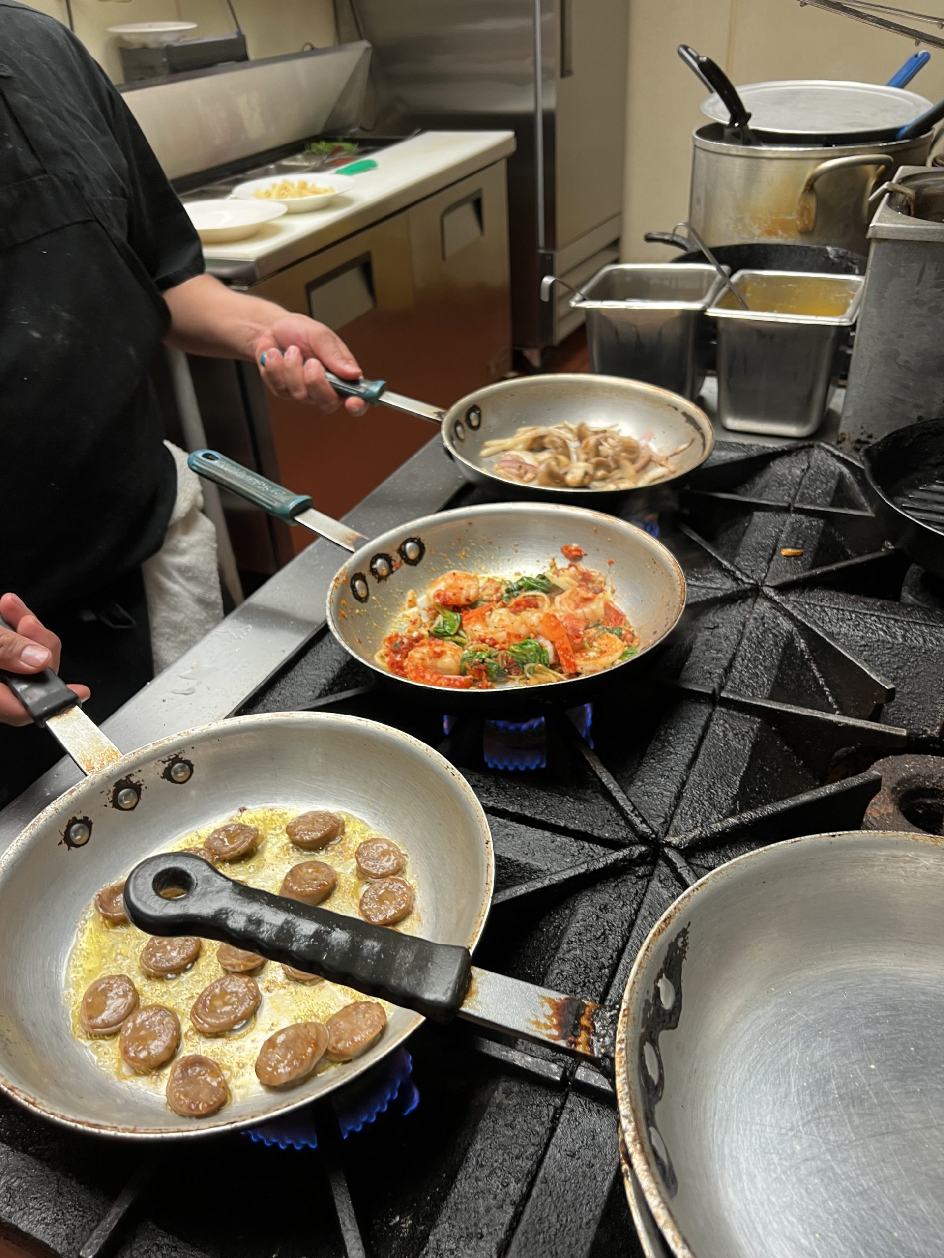 Food cooking in pans on stovetop