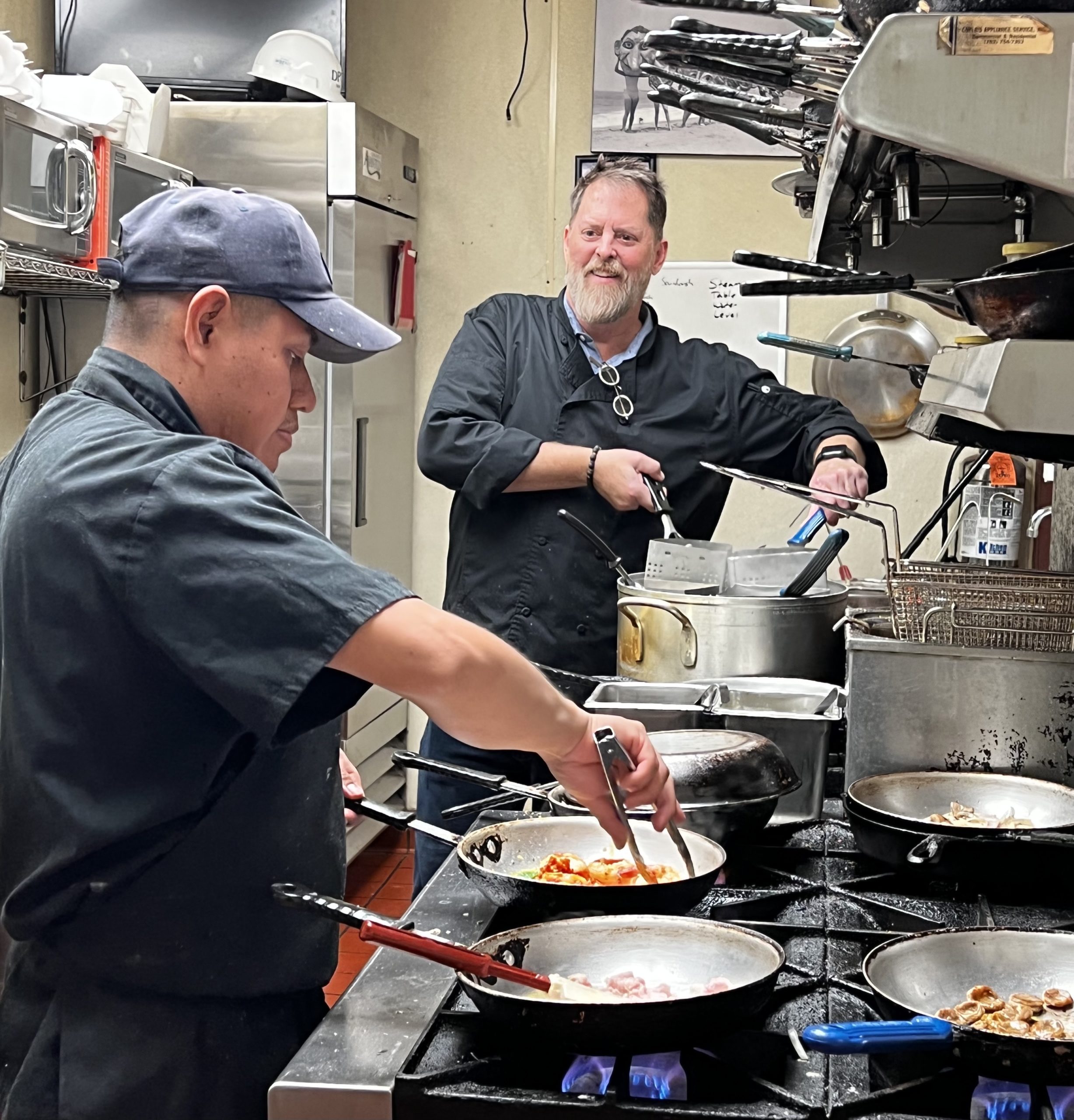 Chefs in kitchen preparing food